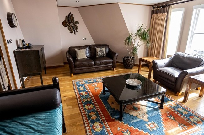 The penthouse suite at Hotel Amsterdam, with plenty of seating to relax.